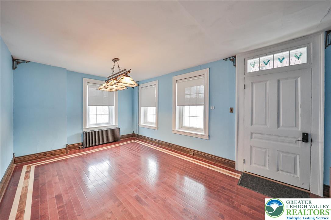 1333 Spring Valley Road Bethlehem, PA 18015 - Photo 8 of 40 a view of an empty room with wooden floor and a window