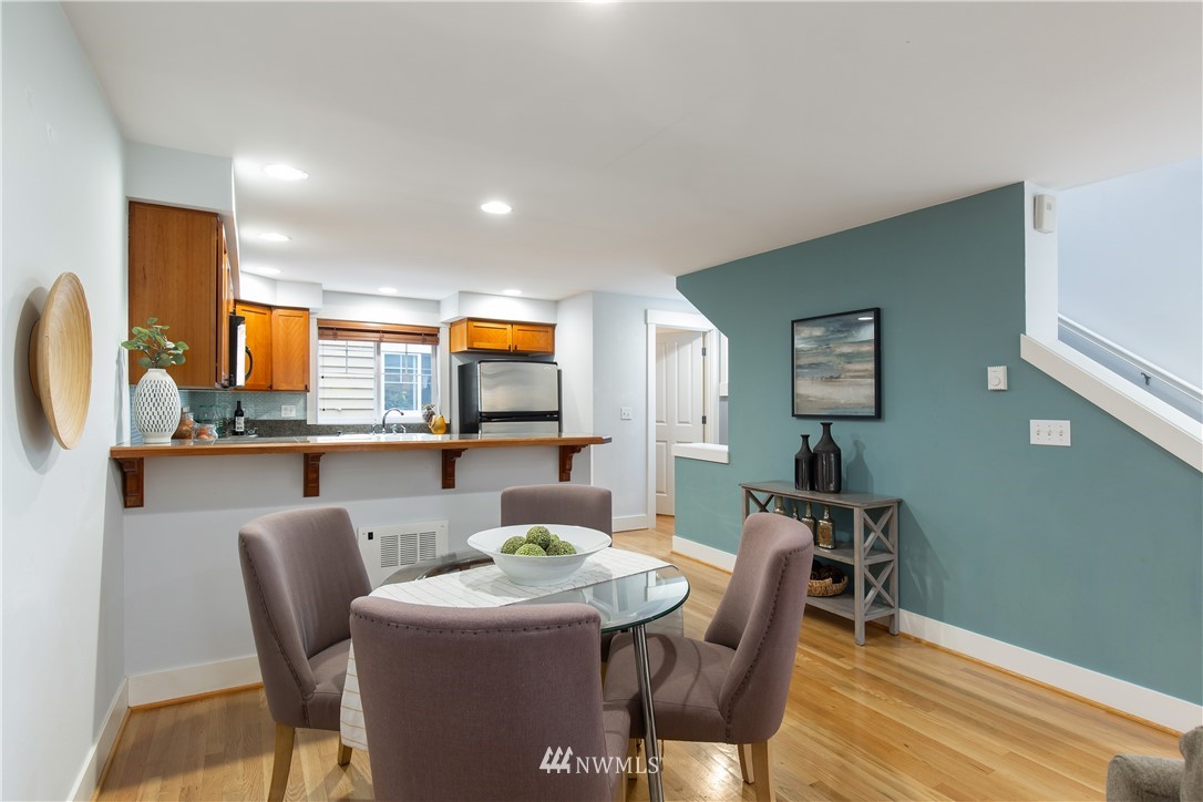 10303 Holman Road North, Unit A Seattle, WA 98177 - Photo 14 of 40 a dining room with furniture and wooden floor