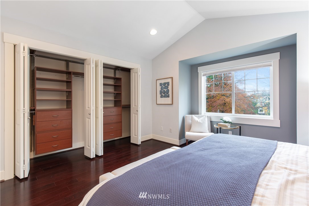 10303 Holman Road North, Unit A Seattle, WA 98177 - Photo 25 of 40 a bedroom with a bed and wooden floor