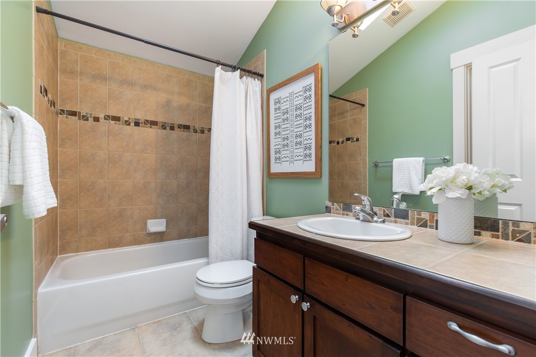 10303 Holman Road North, Unit A Seattle, WA 98177 - Photo 27 of 40 a bathroom with a sink a toilet and shower