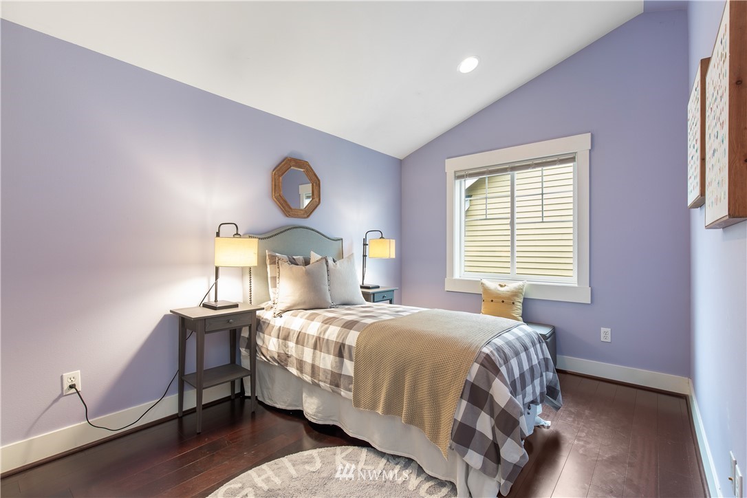 10303 Holman Road North, Unit A Seattle, WA 98177 - Photo 28 of 40 a bedroom with a bed and a lamp on dresser
