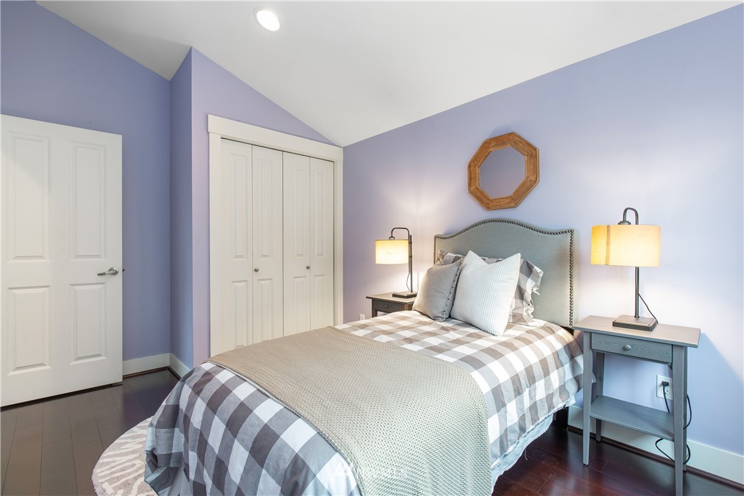 10303 Holman Road North, Unit A Seattle, WA 98177 - Photo 29 of 40 a bedroom with bed and wooden floor