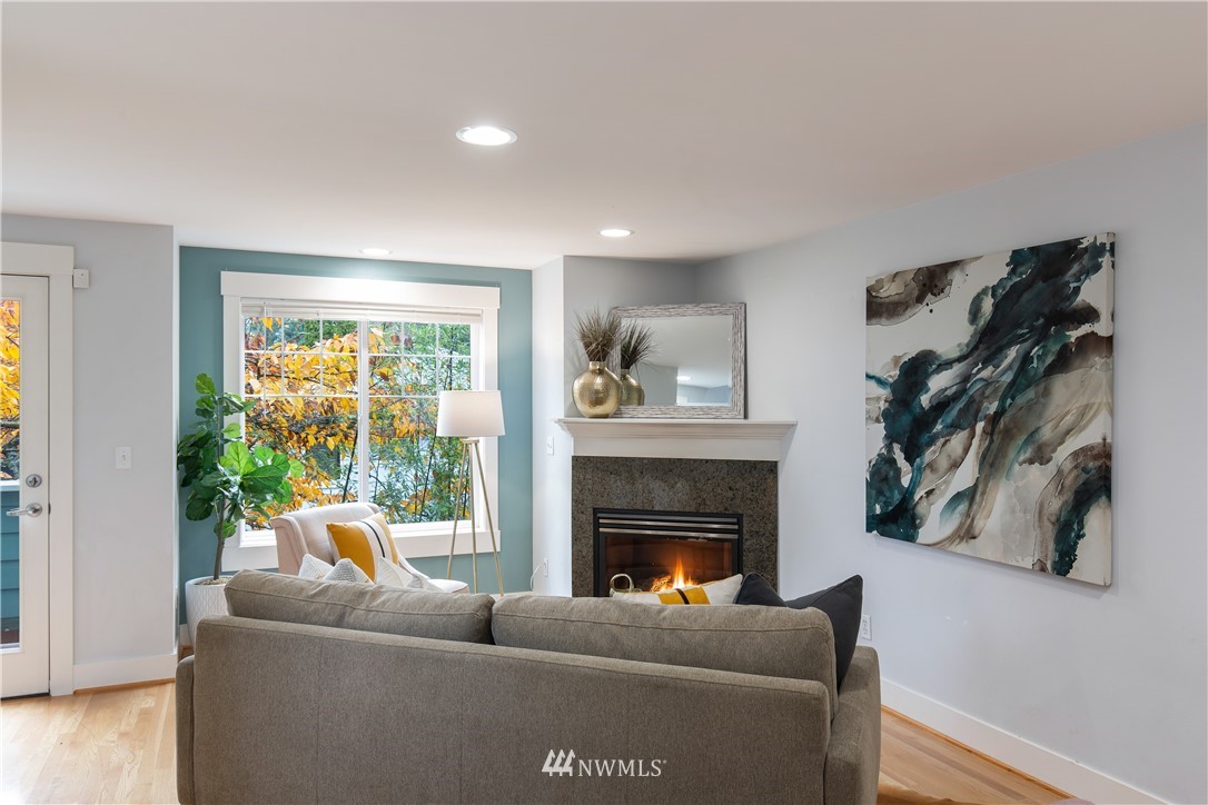 10303 Holman Road North, Unit A Seattle, WA 98177 - Photo 6 of 40 a living room with furniture and a fireplace