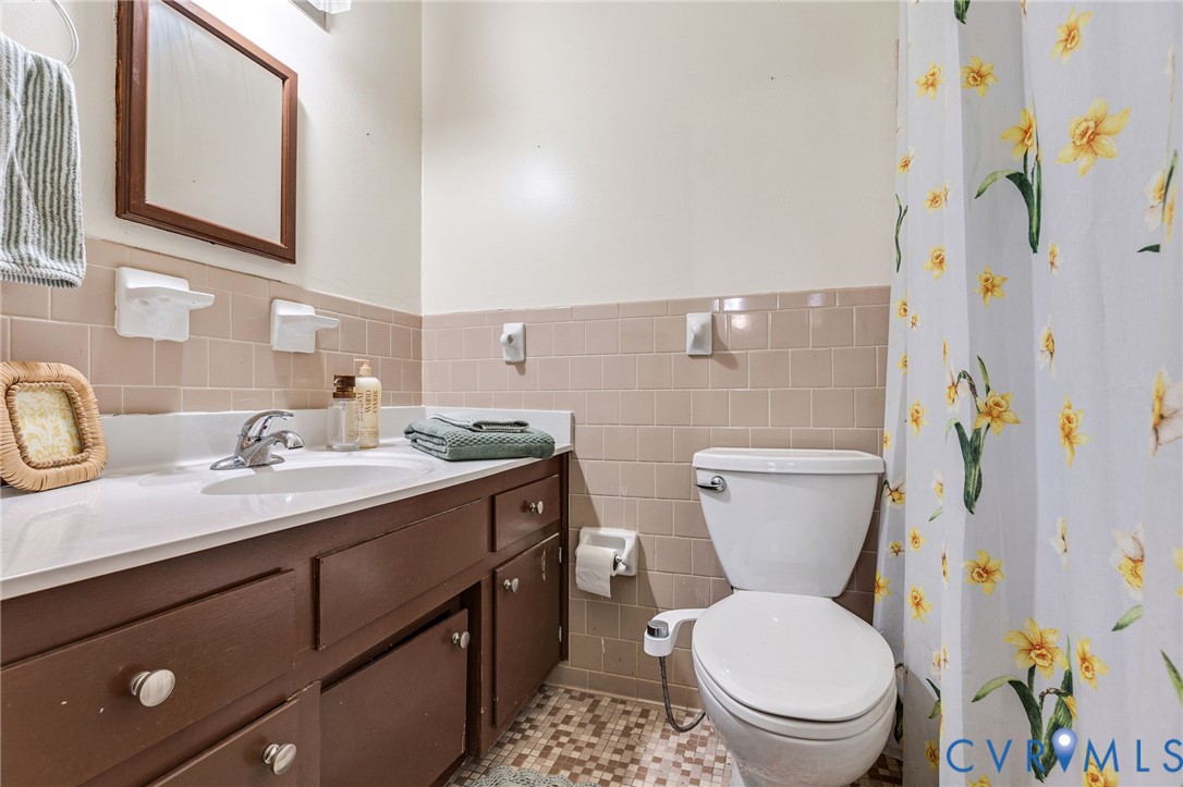 5904 Sutherland Drive Sutherland, VA 23885 - Photo 18 of 20 a bathroom with a granite countertop toilet sink and a mirror