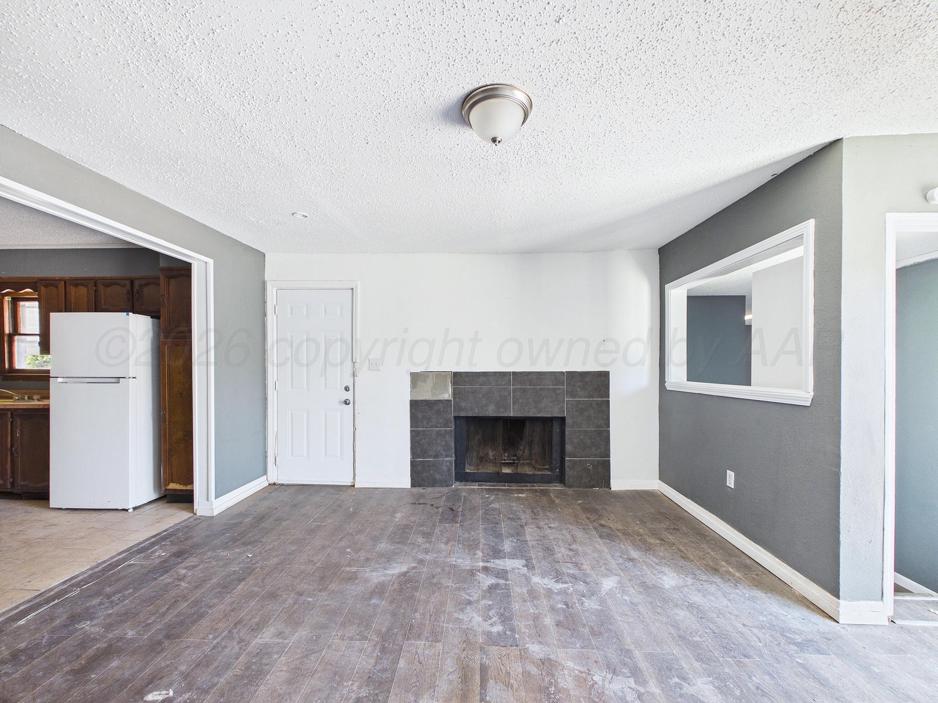 4311 Bowie Street Amarillo, TX 79110 - Photo 11 of 36 a view of empty room with a fireplace