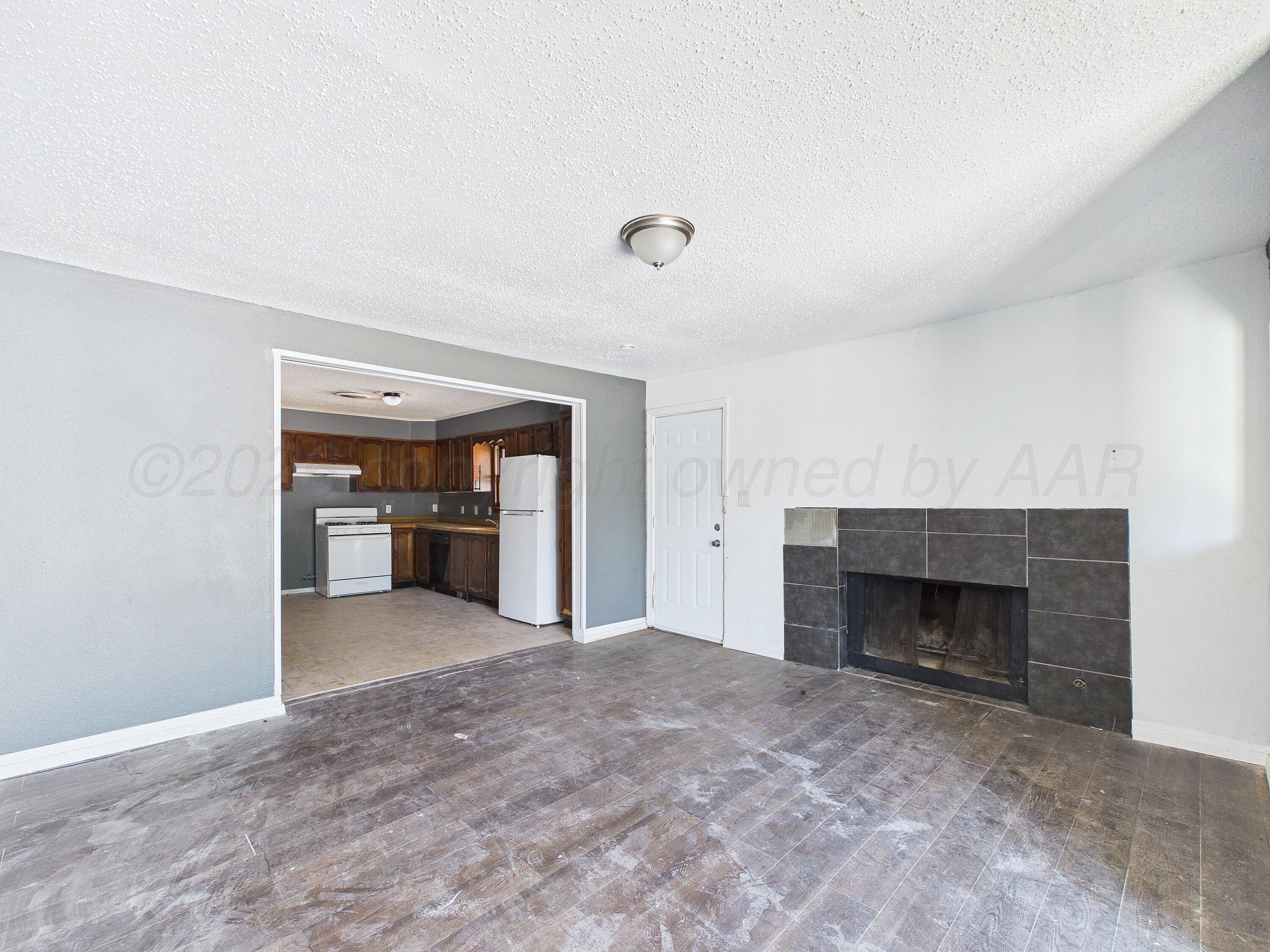 4311 Bowie Street Amarillo, TX 79110 - Photo 12 of 36 a view of an empty room with a fireplace