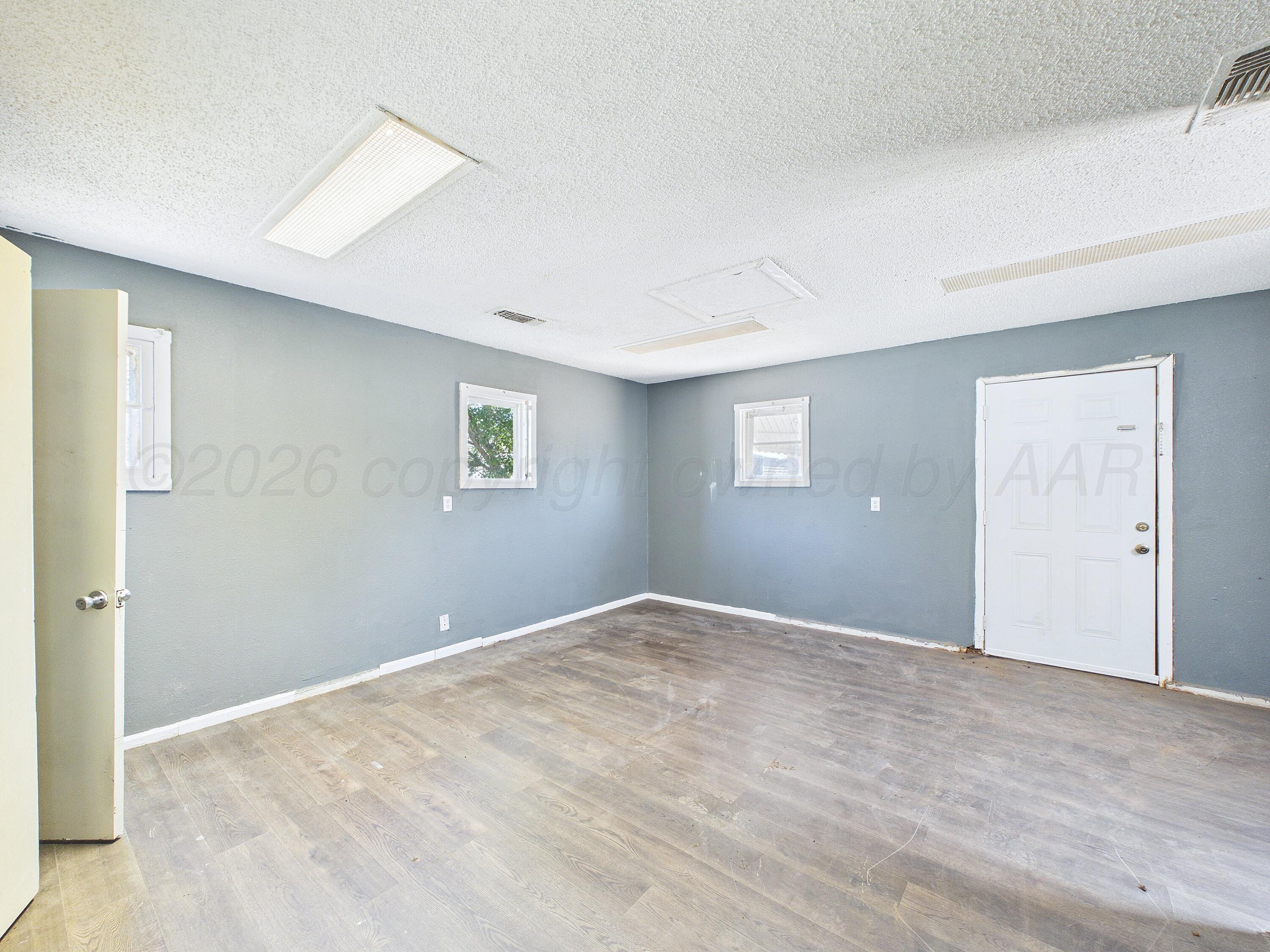 4311 Bowie Street Amarillo, TX 79110 - Photo 16 of 36 a view of an empty room with a window