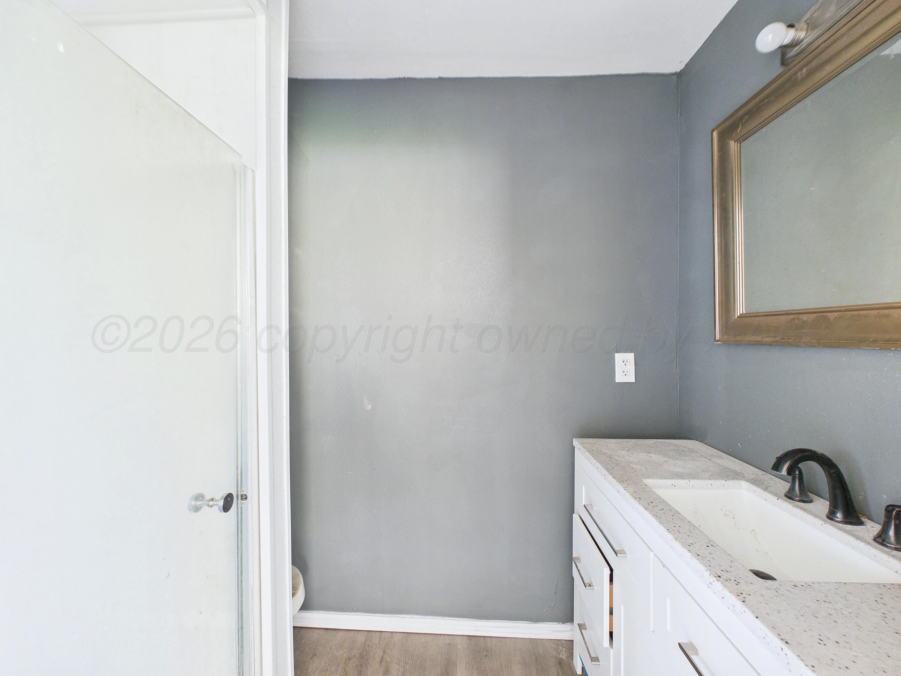 4311 Bowie Street Amarillo, TX 79110 - Photo 20 of 36 a bathroom with a sink and a mirror