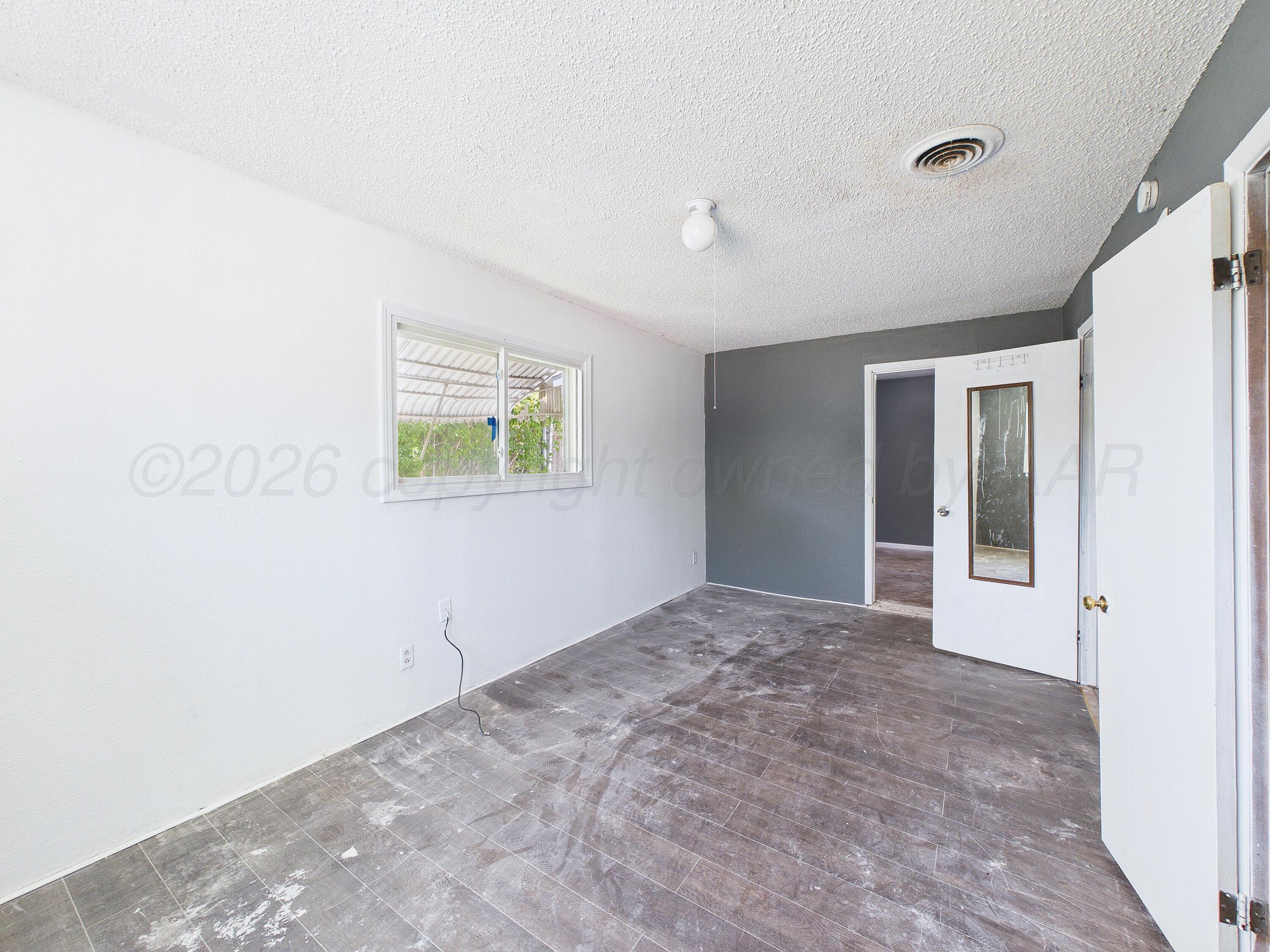 4311 Bowie Street Amarillo, TX 79110 - Photo 24 of 36 a view of an empty room with window and closet area