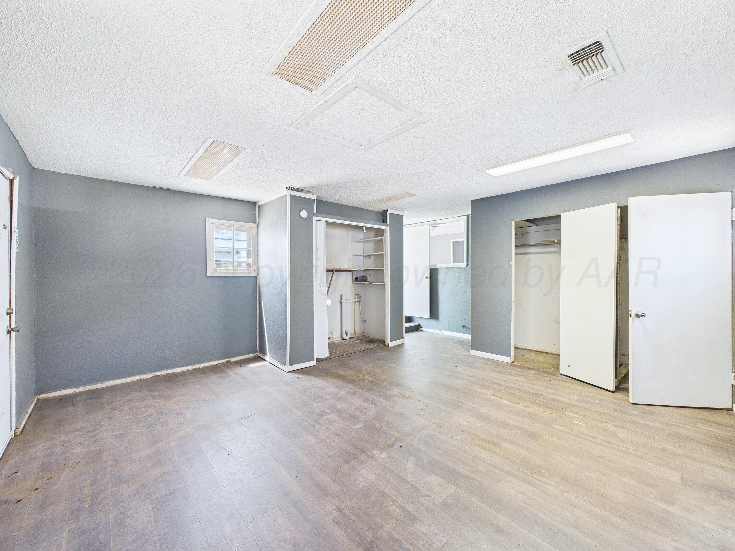 4311 Bowie Street Amarillo, TX 79110 - Photo 27 of 36 a view of an empty room with window and wooden floor