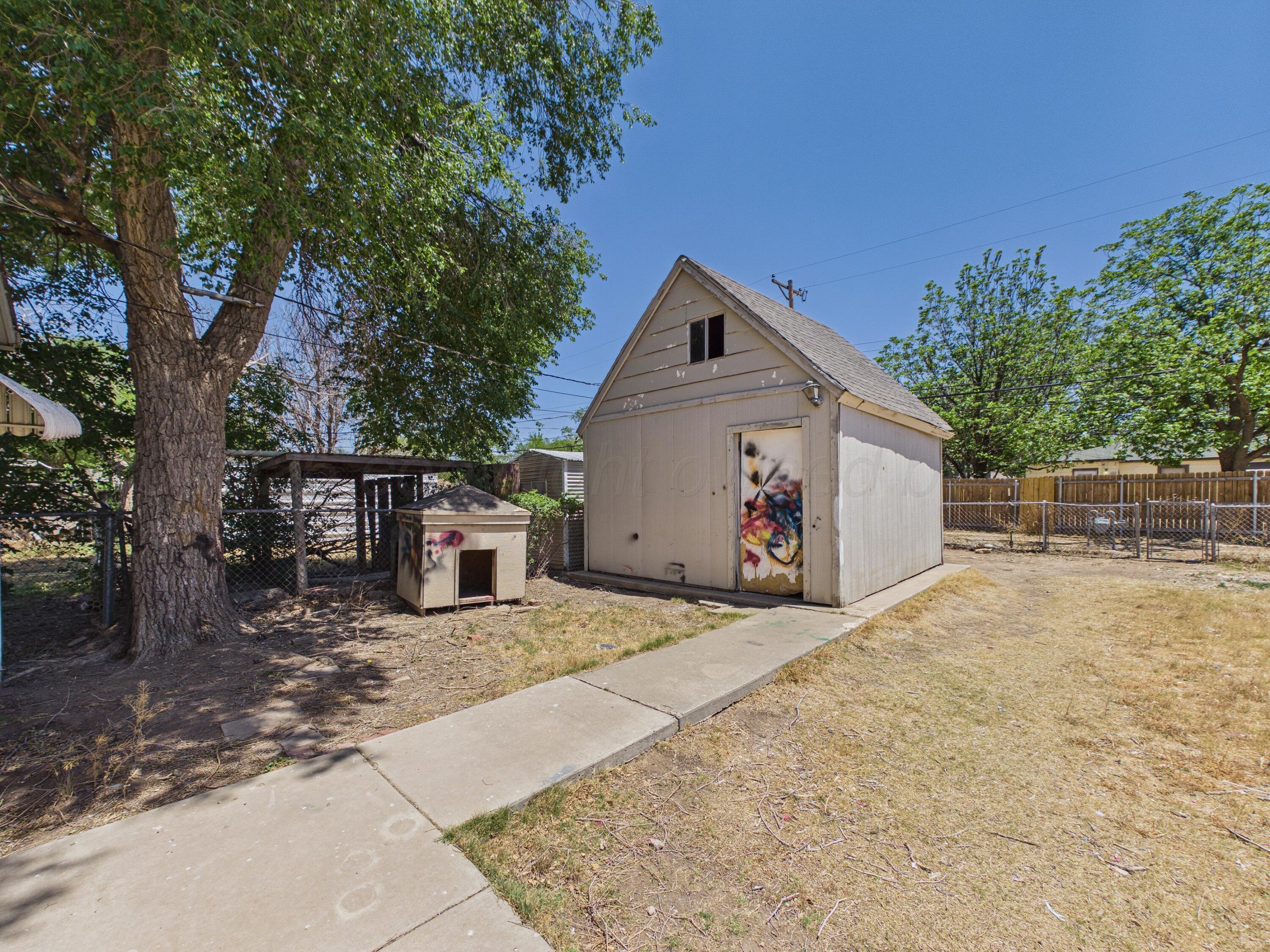 4311 Bowie Street Amarillo, TX 79110 - Photo 31 of 36 a view of a house with backyard and a tree