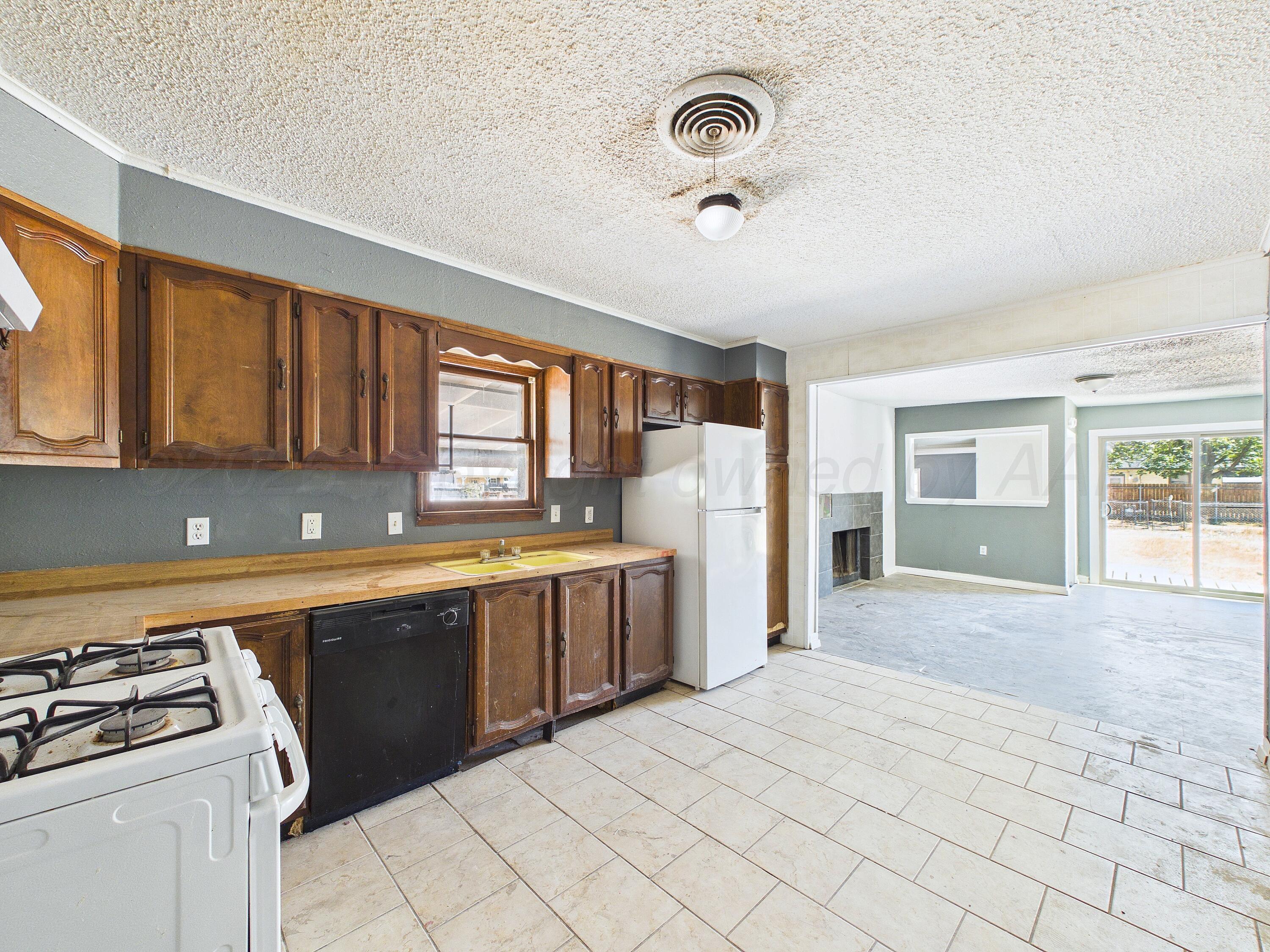 4311 Bowie Street Amarillo, TX 79110 - Photo 10 of 36 a large kitchen with a stove and a sink