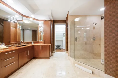 a view of a walk in closet and bedroom with wooden floor
