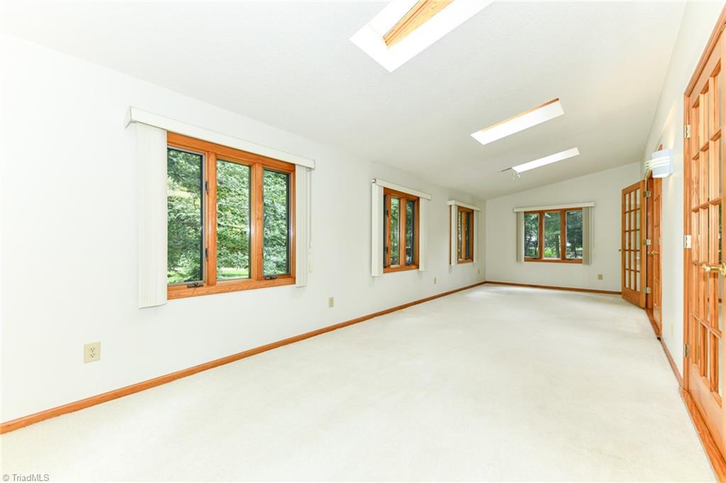 7205 Haw Ridge Road Summerfield, NC 27358 - Photo 14 of 50 Sunroom off great room (not heated/cooled)