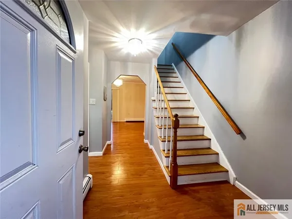 a view of entryway and hall with wooden floor