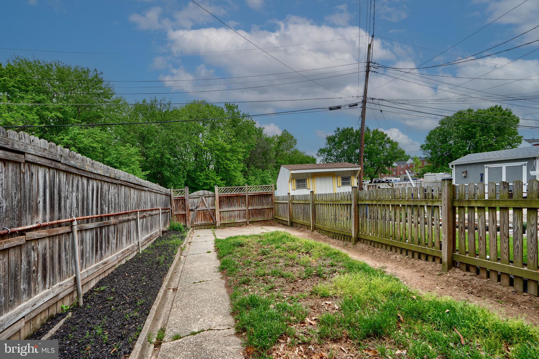 2208 Searles Road Dundalk, MD 21222 - Photo 36 of 39 a view of a pathway with a small yard and wooden fence