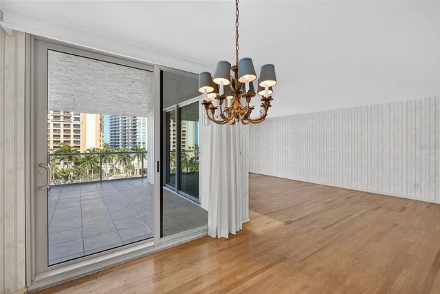 a view of a room with wooden floor and front door
