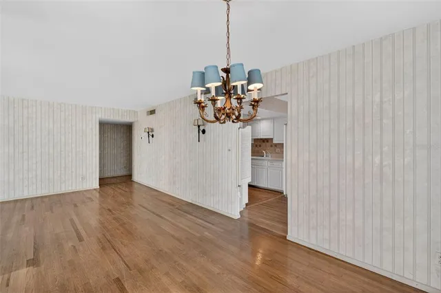 a view of a room with wooden floor