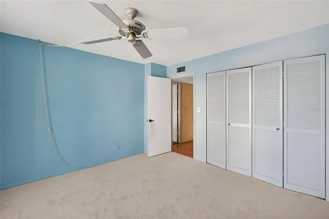 a view of a livingroom with a ceiling fan & a ceiling fan