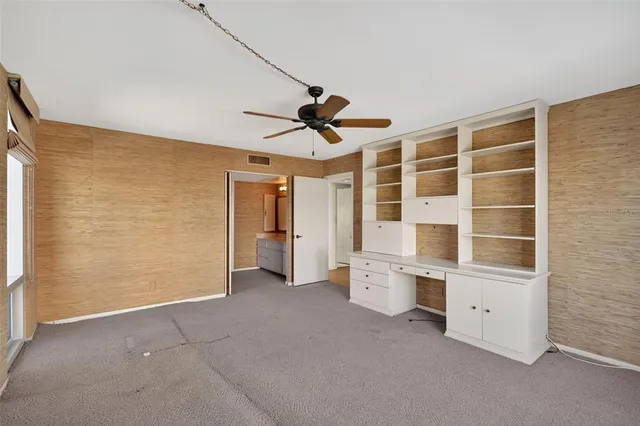 a view of livingroom with furniture ceiling fan and window