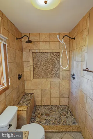 a bathroom with a toilet sink and shower
