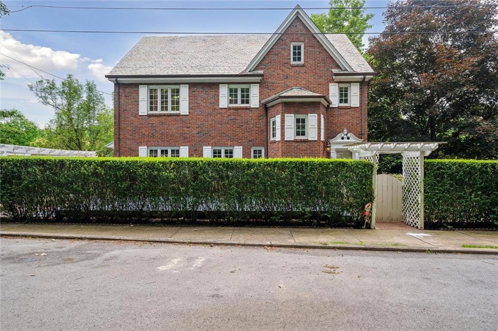 a front view of a house with a garden