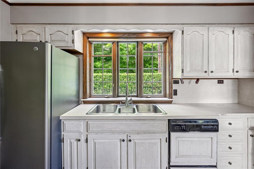 705 Chestnut Street Emlenton, PA 16373 - Photo 12 of 48 a kitchen with stainless steel appliances granite countertop a sink a stove and a refrigerator