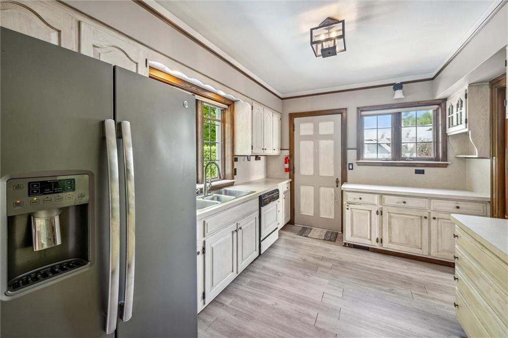 705 Chestnut Street Emlenton, PA 16373 - Photo 15 of 48 a open kitchen with granite countertop a refrigerator oven a sink dishwasher and white cabinets with wooden floor