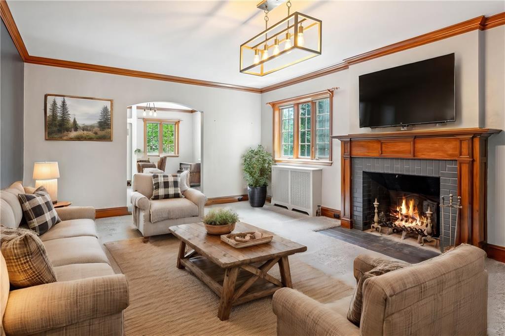 705 Chestnut Street Emlenton, PA 16373 - Photo 6 of 48 a living room with furniture a flat screen tv and a fireplace