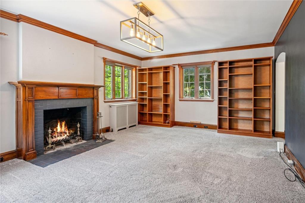 705 Chestnut Street Emlenton, PA 16373 - Photo 7 of 48 a view of an empty room with a fireplace and a window