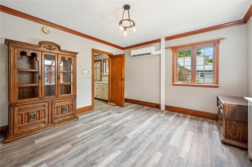 705 Chestnut Street Emlenton, PA 16373 - Photo 10 of 48 a view of an empty room with wooden floor and a window