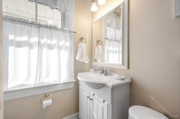 a kitchen with stainless steel appliances white cabinets a sink and a window