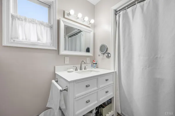 a bed room with a bed window and a desk