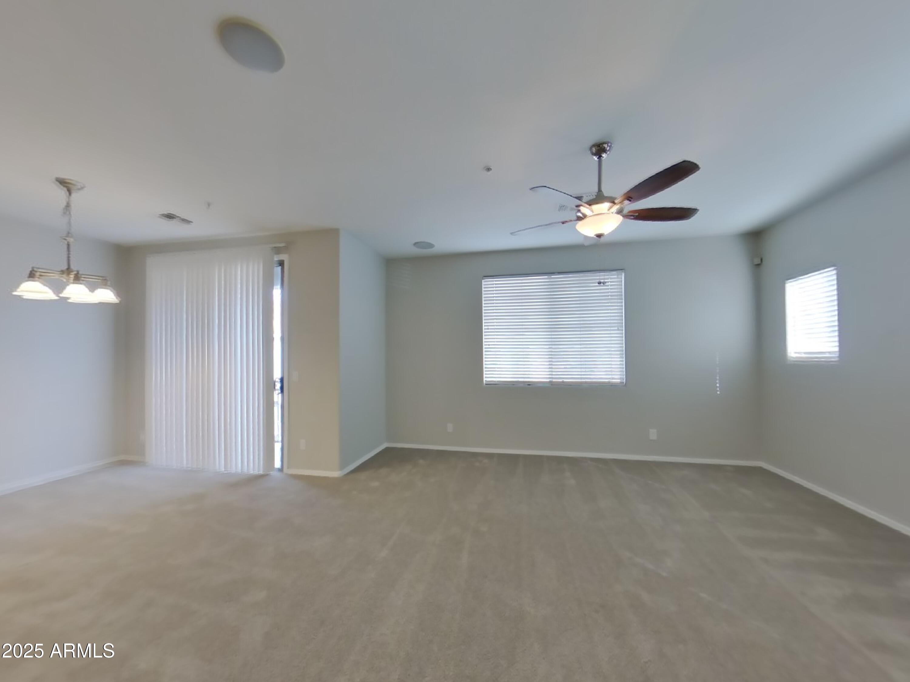 1250 South Rialto, Unit 71 Mesa, AZ 85209 - Photo 2 of 13 an empty room with windows and fan