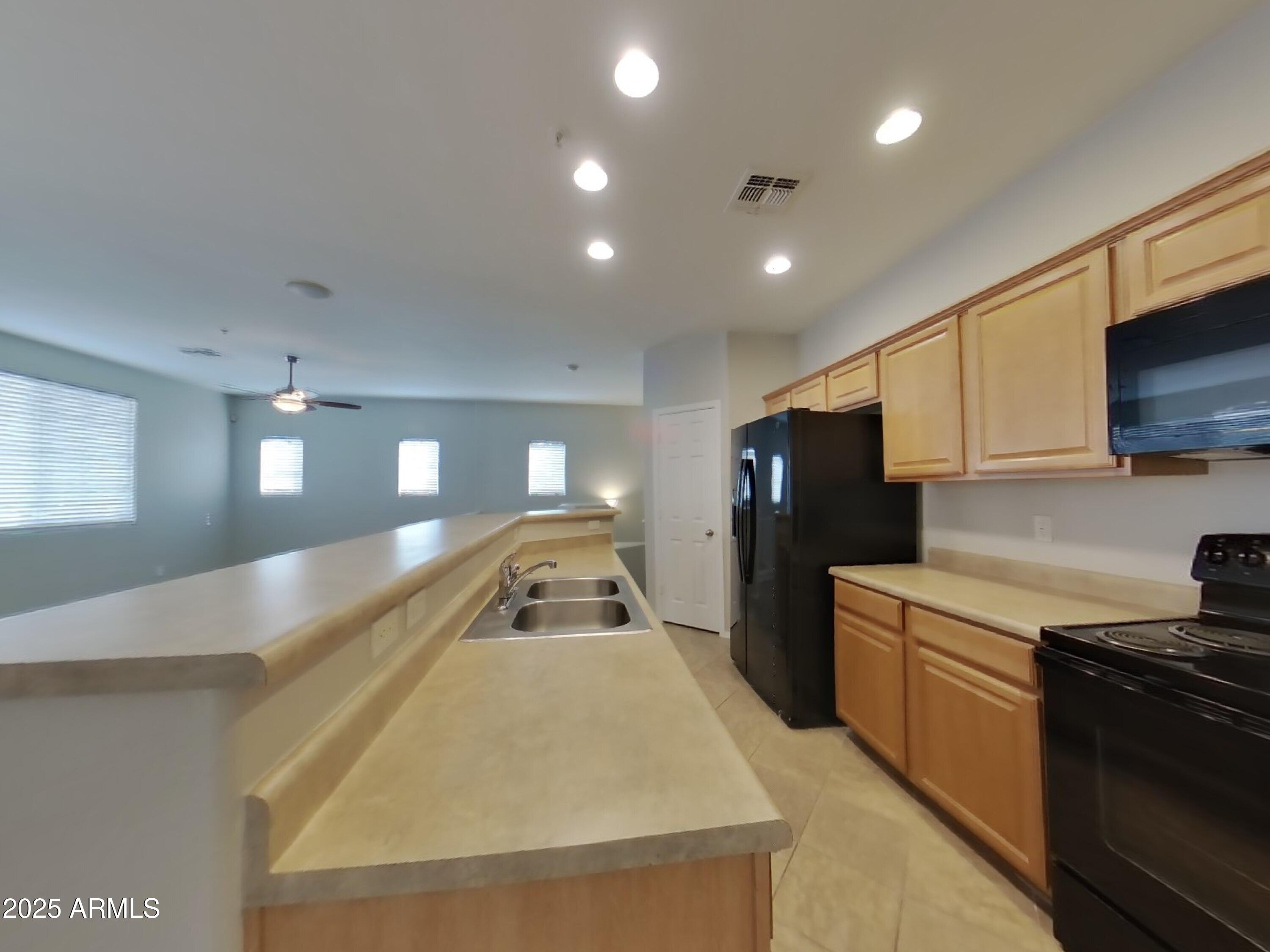 1250 South Rialto, Unit 71 Mesa, AZ 85209 - Photo 4 of 13 a view of a kitchen with a sink and dishwasher a refrigerator with wooden floor