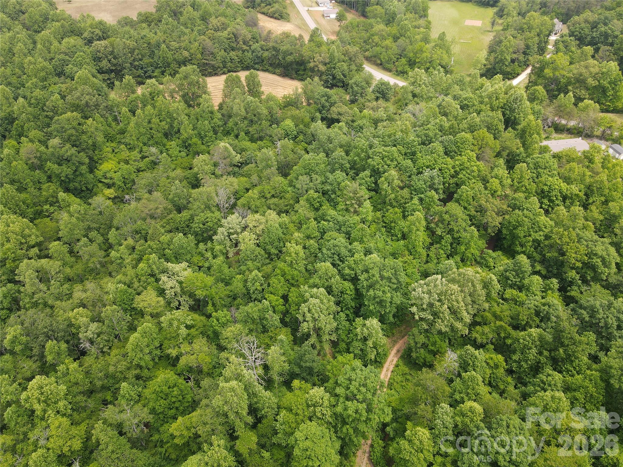6 Hopewell Church Road, Unit 6 Hiddenite, NC 28636 - Photo 19 of 33 an aerial view of residential house with outdoor space and trees all around