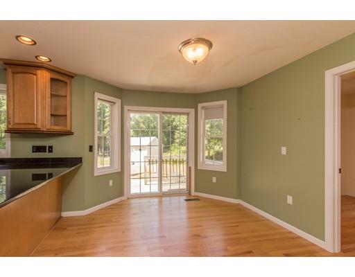 429 Ashby Road Ashburnham, MA 01430 - Photo 4 of 24 a view of an empty room with wooden floor and a window