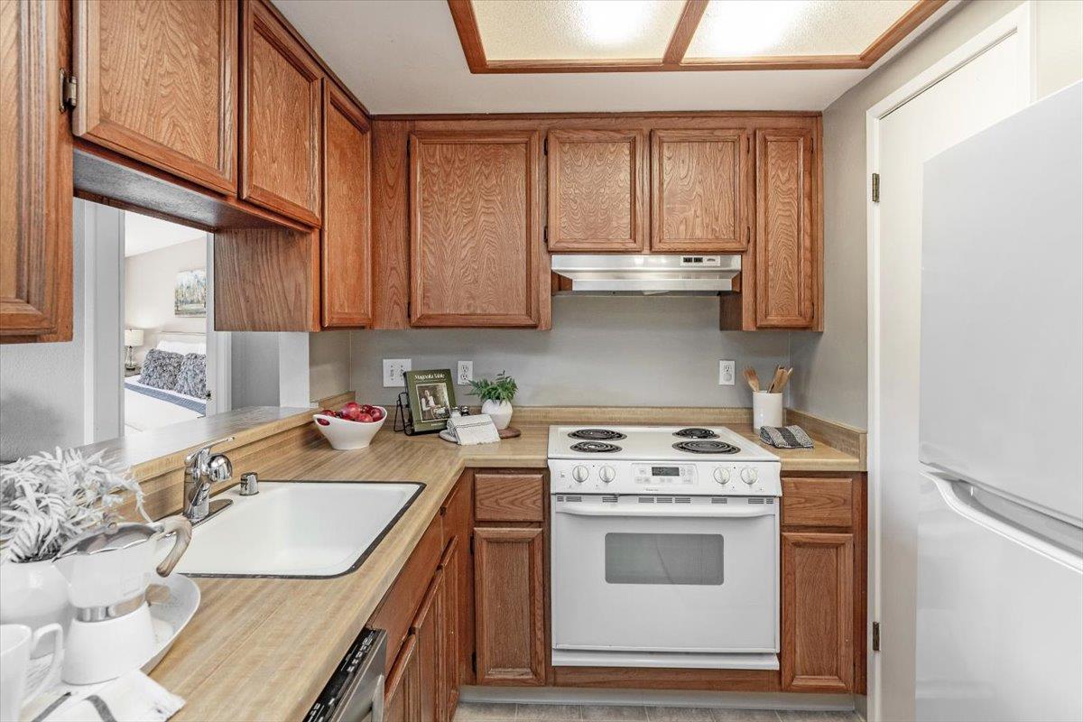 18952 Sara Park Circle Saratoga, CA 95070 - Photo 5 of 21 a kitchen with granite countertop a sink stove and cabinets