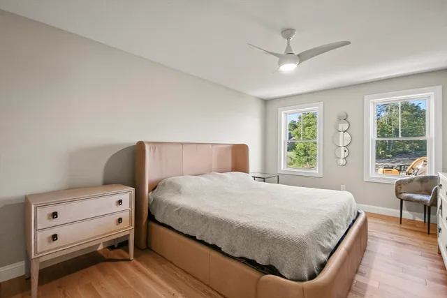 a bedroom with a bed and a chair