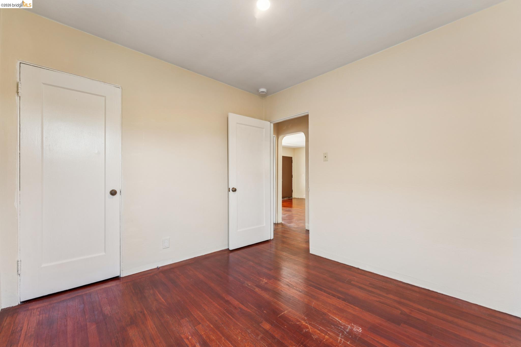 2879 Rheem Avenue Richmond, CA 94804 - Photo 34 of 45 Room featuring rich wood-finish flooring, light-toned wall paint, and white trim