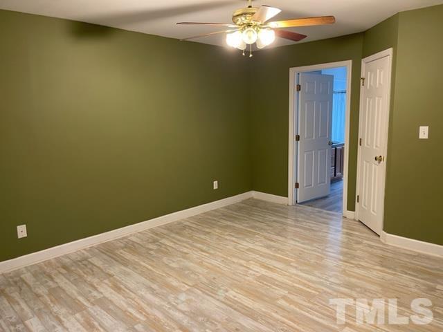 4320 Major Loring Way Raleigh, NC 27616 - Photo 24 of 37 a view of empty room with a fan and wooden floor
