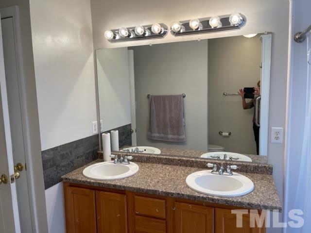 4320 Major Loring Way Raleigh, NC 27616 - Photo 25 of 37 a bathroom with sinks and a mirror