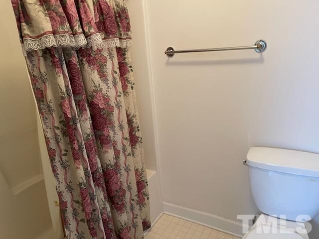 4320 Major Loring Way Raleigh, NC 27616 - Photo 35 of 37 a bathroom with a shower curtain and toilet