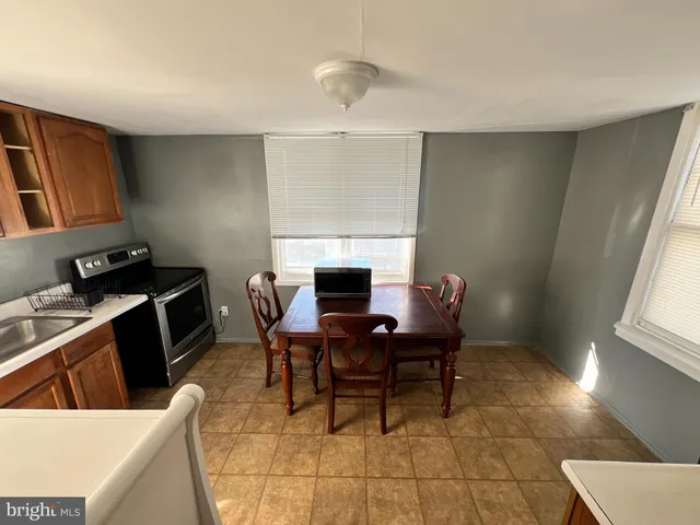 a dining room with furniture and window