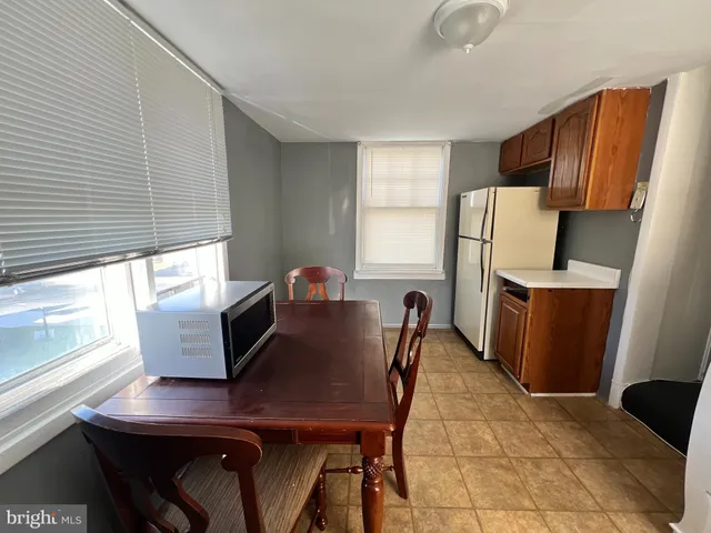 a view of a dining room with furniture and a window