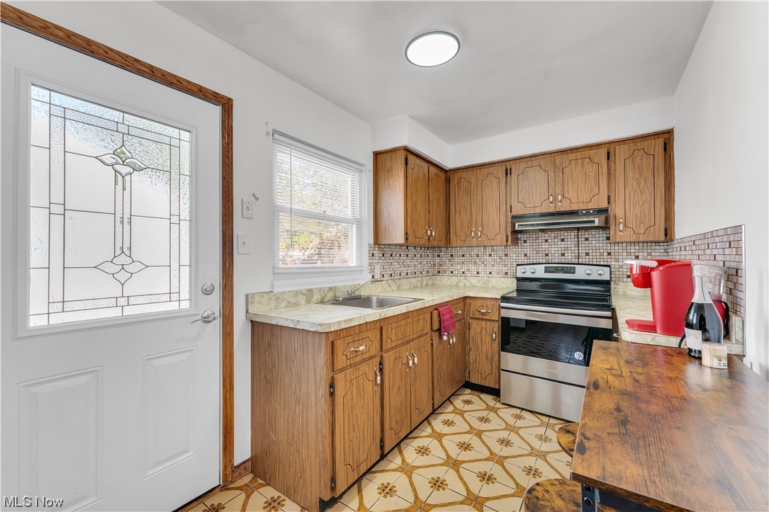 6625 Ridgeview Road Cleveland, OH 44124 - Photo 12 of 24 Kitchen featuring sink, light tile floors, tasteful backsplash, and stainless steel electric range oven
