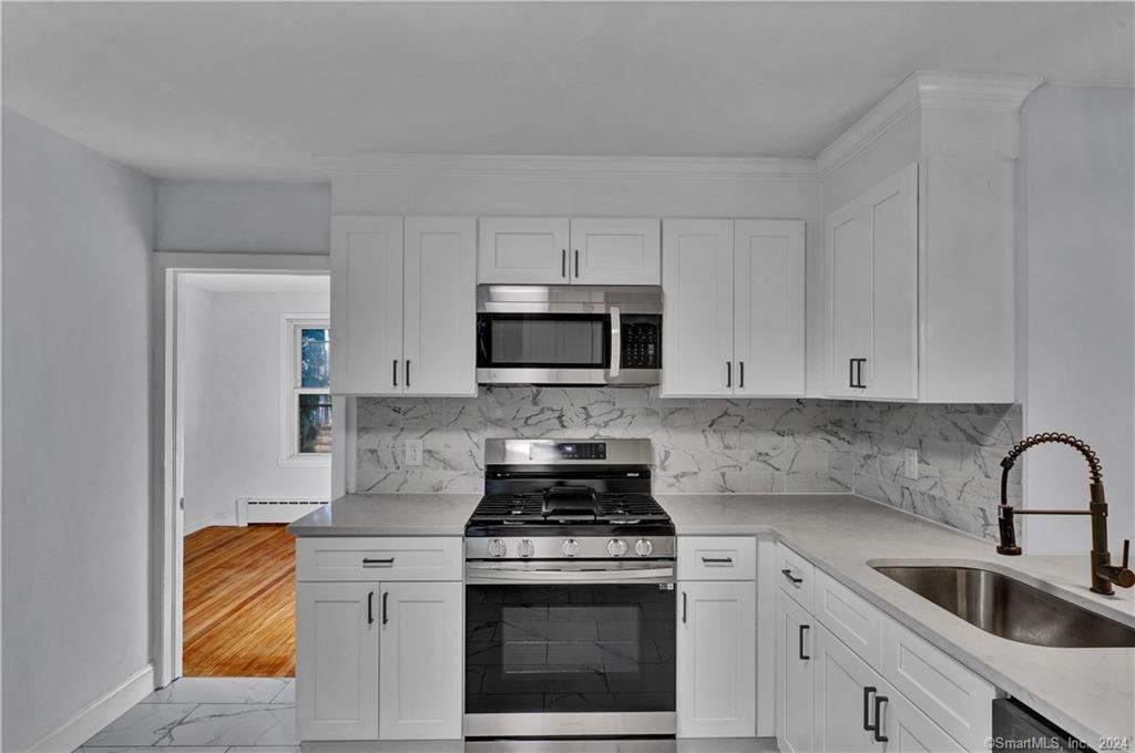 11 Frederick Street Killingly, CT 06239 - Photo 1 of 1 a kitchen with stainless steel appliances granite countertop white cabinets a stove a sink and dishwasher