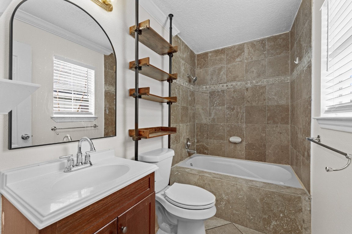 842 East 29th Street Houston, TX 77009 - Photo 14 of 24 a bathroom with a sink toilet a mirror and shower