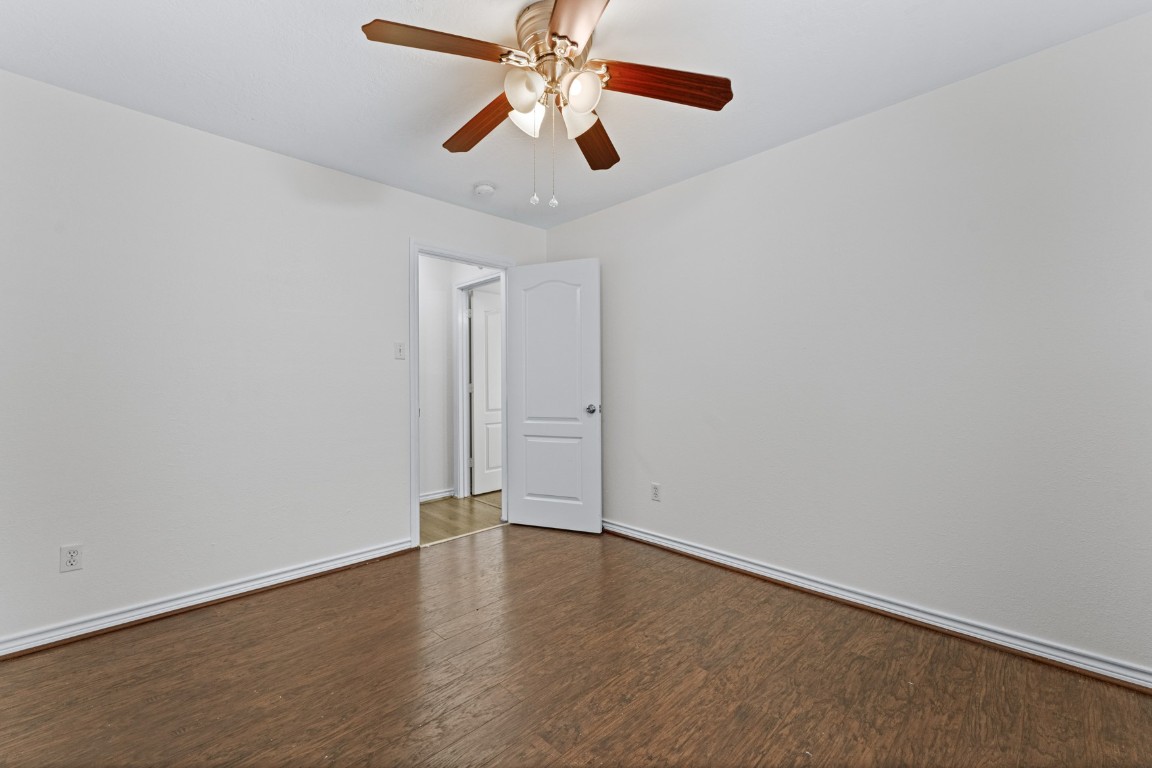 842 East 29th Street Houston, TX 77009 - Photo 18 of 24 an empty room with wooden floor ceiling fan and window
