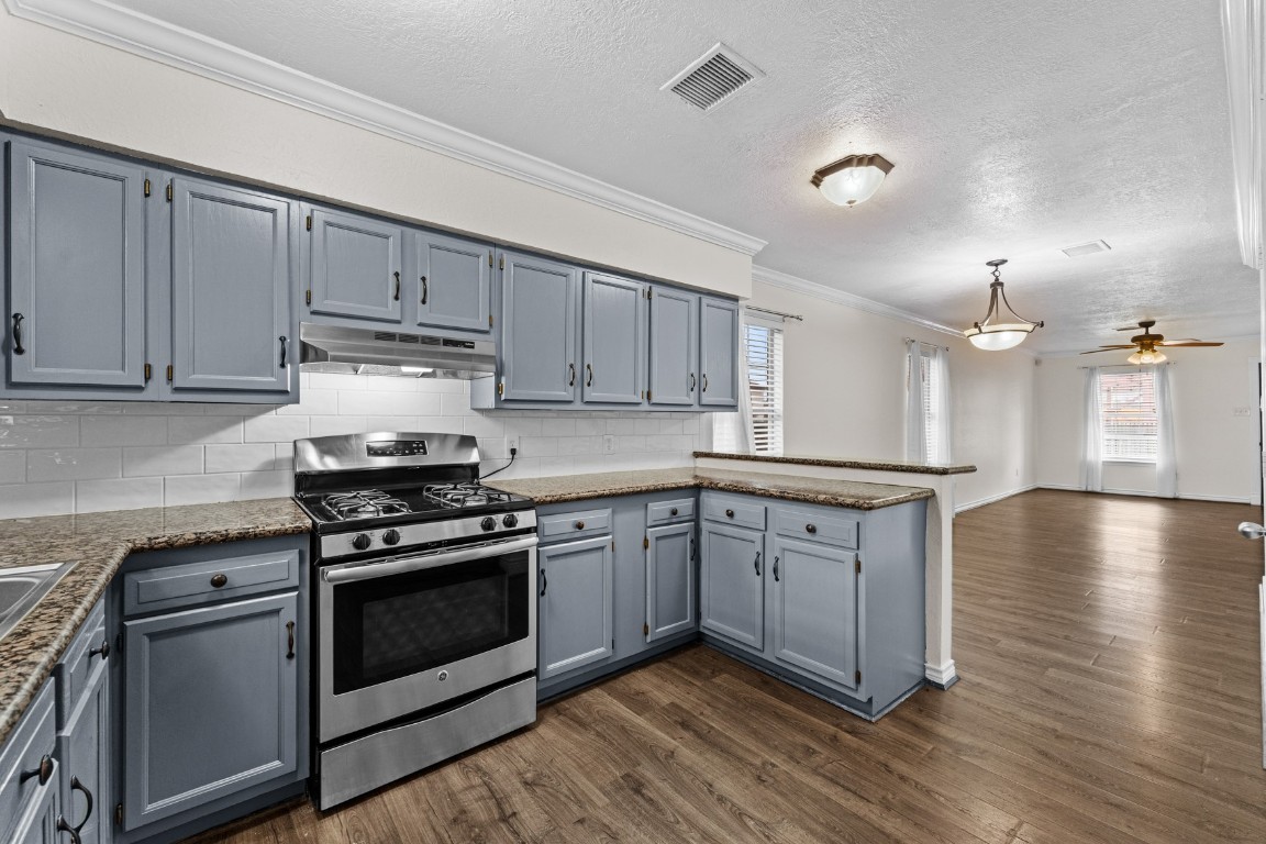 842 East 29th Street Houston, TX 77009 - Photo 2 of 24 a kitchen with stainless steel appliances granite countertop a stove and a sink